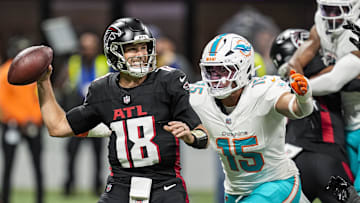 Oct 26, 2025; Atlanta, Georgia, USA; Atlanta Falcons quarterback Kirk Cousins (18) passes under pressure from Miami Dolphins linebacker Jaelan Phillips (15) during the first quarter at Mercedes-Benz Stadium. Mandatory Credit: Dale Zanine-Imagn Images