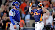 Houston Astros second baseman Jose Altuve (27) crosses home plate after hitting a two-run home run against the Chicago Cubs at Daikin Park. 