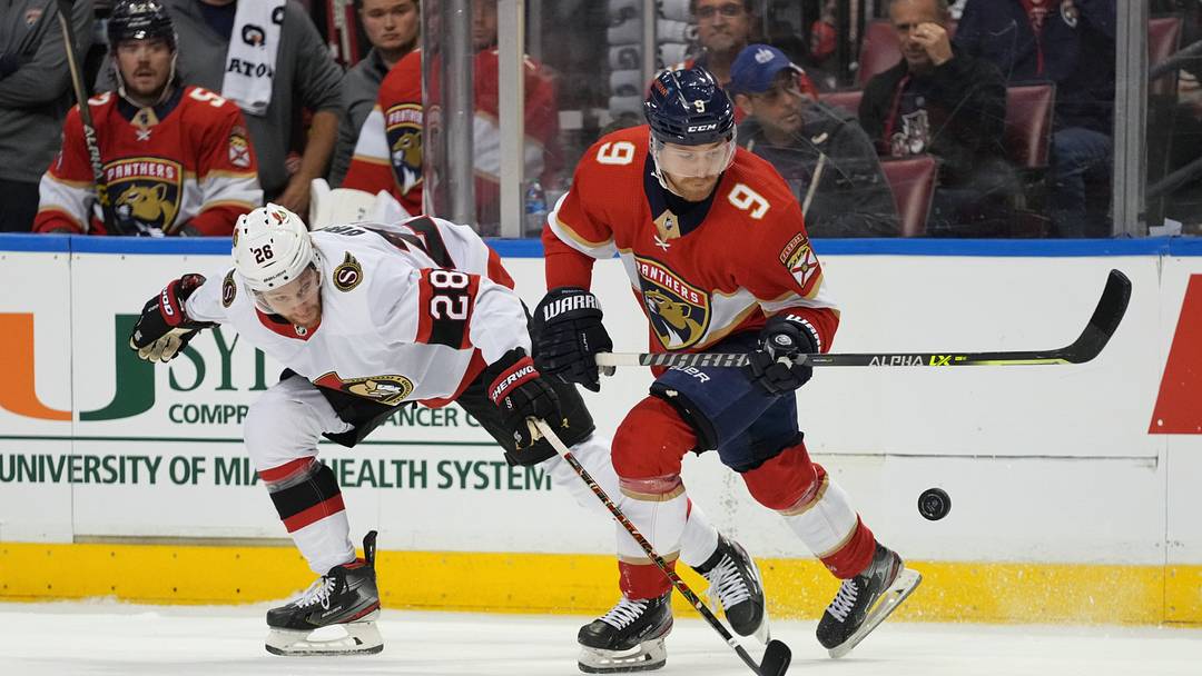 Dec 14, 2021; Sunrise, Florida, USA; Ottawa Senators right wing Connor Brown (28) battles Florida Panthers center Sam Bennett (9) for the puck during the first period at FLA Live Arena. Mandatory Credit: Jasen Vinlove-USA TODAY Sports
