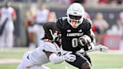 Nov 4, 2023; Louisville, Kentucky, USA;  Louisville Cardinals wide receiver Chris Bell (0) runs the ball against the Virginia Tech Hokies during the first quarter at L&N Federal Credit Union Stadium. Mandatory Credit: Jamie Rhodes-Imagn Images
