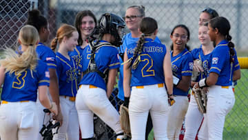 Camden-Wyoming's Alyssa Powell (third from right) is surrounded by her teammates after she started a double play by making a catch on a line drive and doubling up a Newark American-Canal runner in Camden-Wyoming's 18-0 win. 