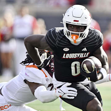 Nov 4, 2023; Louisville, Kentucky, USA;  Louisville Cardinals wide receiver Chris Bell (0) runs the ball against the Virginia Tech Hokies during the first quarter at L&N Federal Credit Union Stadium. Mandatory Credit: Jamie Rhodes-Imagn Images