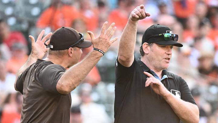 Jun 13, 2026; Baltimore, Maryland, USA;  Umpire Chris Conroy (98) ejects San Diego Padres manager Craig Stammen (14) from the game during the ninth inning against the Baltimore Orioles at Oriole Park at Camden Yards. Mandatory Credit: James A. Pittman-Imagn Images