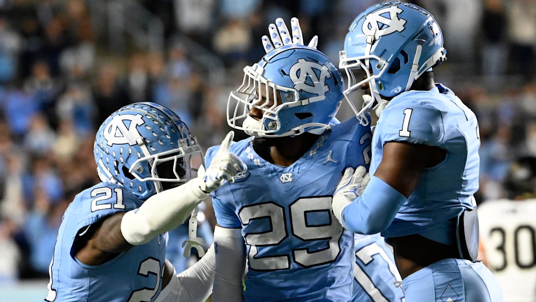 Nov 16, 2024; Chapel Hill, North Carolina, USA; North Carolina Tar Heels defensive back Marcus Allen (29) reacts with defensive backs Kaleb Cost (21) and Antavious Lane (1) after intercepting the ball in the third quarter at Kenan Memorial Stadium. Mandatory Credit: Bob Donnan-Imagn Images