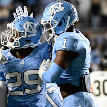Nov 16, 2024; Chapel Hill, North Carolina, USA; North Carolina Tar Heels defensive back Marcus Allen (29) reacts with defensive backs Kaleb Cost (21) and Antavious Lane (1) after intercepting the ball in the third quarter at Kenan Memorial Stadium. Mandatory Credit: Bob Donnan-Imagn Images