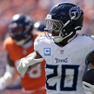 Sep 7, 2025; Denver, Colorado, USA;Tennessee Titans running back Tony Pollard (20) rushes the ball against the Denver Broncos in the first half at Empower Field at Mile High. Mandatory Credit: Isaiah J. Downing-Imagn Images