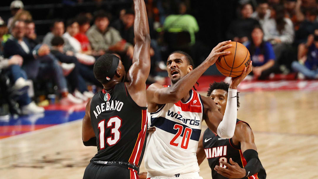 [US, Mexico & Canada customers only] Nov 2, 2024; Mexico City, MEXICO;  Washington Wizards player Alexandre Sarr shoots against Miami Heat player Bam Adebayo during a NBA basketball game at Arena CDMX. Mandatory Credit: Henry Romero/Reuters via Imagn Images