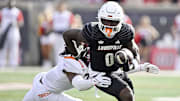 Nov 4, 2023; Louisville, Kentucky, USA;  Louisville Cardinals wide receiver Chris Bell (0) runs the ball against the Virginia Tech Hokies during the first quarter at L&N Federal Credit Union Stadium. Mandatory Credit: Jamie Rhodes-Imagn Images