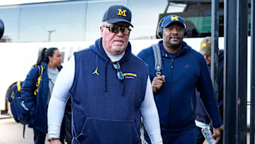 Michigan defensive coordinator Wink Martindale, center, and wide receivers coach Ron Bellamy, right, walk off the bus as team arrive for the game between Ohio State and Michigan at Ohio Stadium in Columbus, Ohio on Saturday, Nov. 30, 2024.
