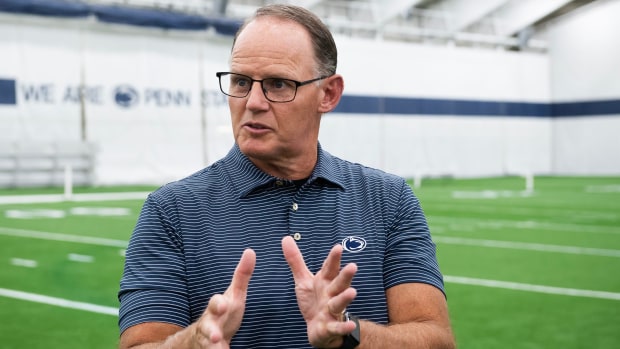 Penn State defensive coordinator Tom Allen holds out his hands as he talks with a reporter.