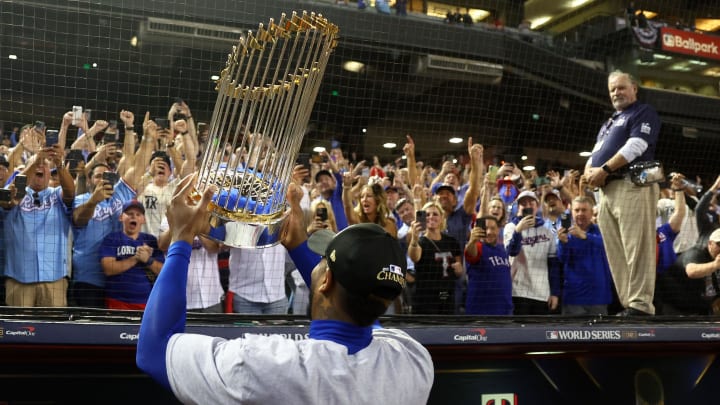 Nov 1, 2023; Phoenix, Arizona, USA;  Texas Rangers relief pitcher Aroldis Chapman (45) holds the trophy up for the fans after winning the 2023 World Series in five games against the Arizona Diamondbacks at Chase Field. Mandatory Credit: Mark J. Rebilas-USA TODAY Sports