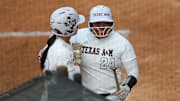 Texas A&M infielder Mya Perez (24) reacts to her run with Texas A&M infielder Koko Wooley (3) during a game against Texas at Jack Turner Stadium.