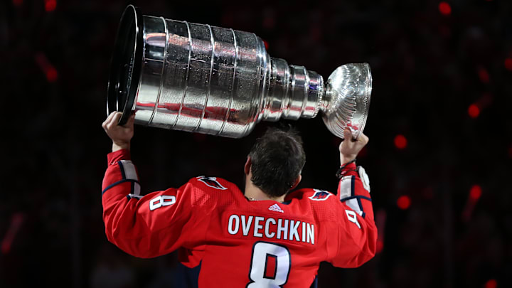 Oct 3, 2018; Washington, DC, USA; Washington Capitals left wing Alex Ovechkin (8) hoists the Stanley Cup before the game against the Boston Bruins at Capital One Arena. Mandatory Credit: Geoff Burke-Imagn Images