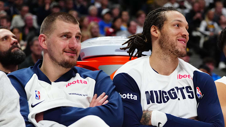 Dec 23, 2024; Denver, Colorado, USA; Denver Nuggets center Nikola Jokic (15) and forward Aaron Gordon (32) and forward Michael Porter Jr. (1) on the bench in the fourth quarter against the Phoenix Suns at Ball Arena. Mandatory Credit: Ron Chenoy-Imagn Images