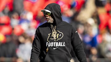 Nov 23, 2024; Kansas City, Missouri, USA;  Colorado head coach Deion Sanders watches his players warmup prior to the game between the Kansas Jayhawks and the Colorado Buffaloes at GEHA Field at Arrowhead Stadium. 