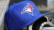 Apr 16, 2025; Toronto, Ontario, CAN; A Toronto Blue Jays hat and glove in the dugout during a game against the Atlanta Braves at Rogers Centre. 