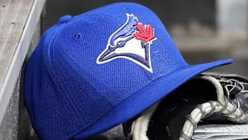 Apr 16, 2025; Toronto, Ontario, CAN; A Toronto Blue Jays hat and glove in the dugout during a game against the Atlanta Braves at Rogers Centre. 
