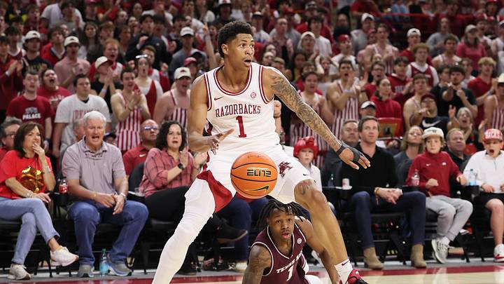 Feb 25, 2026; Fayetteville, Arkansas, USA; Arkansas Razorbacks guard Meleek Thomas (1) steals the ball from Texas A&M Aggies guard Josh Holoway (1) during the first half at Bud Walton Arena. Mandatory Credit: Nelson Chenault-Imagn Images