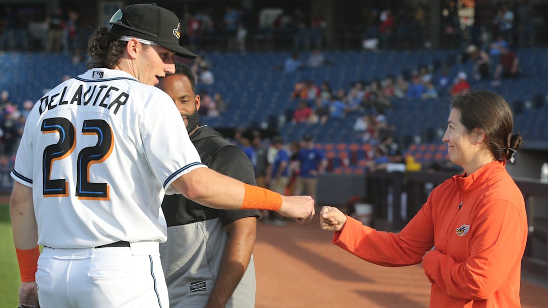 Akron RubberDucks assistant athletic trainer Karina Gonzalez gets a first bump from Chase DeLauter before the game against Erie on Tuesday, April 16, 2024, in Akron, Ohio. [Phil Masturzo/ Beacon Journal]