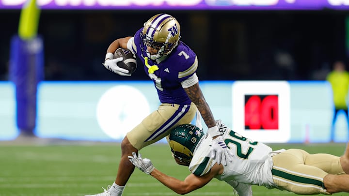 Huskies freshman Raiden Vines-Bright (7) tries to evade a tackler in Washington's season-opening game against Colorado State at Husky Stadium on August 30, 2025.