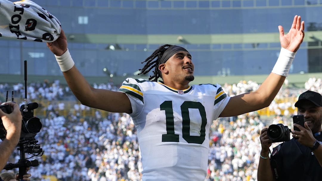Green Bay Packers quarterback Jordan Love celebrates as he runs off the field following the game against the Houston Texans.
