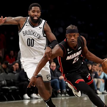 Oct 6, 2022; Brooklyn, New York, USA; Miami Heat forward Jimmy Butler (22) drives to the basket against Brooklyn Nets forward Royce O'Neale (00) during the first quarter at Barclays Center. Mandatory Credit: Brad Penner-Imagn Images