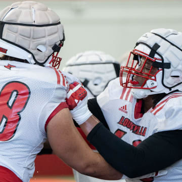 Louisville football offensive linemen Rasheed Miller (60) and Michael Gonzalez (68) run drills during spring practice on Saturday, March 23, 2024 at the Trager practice facility in Louisville, Ky.