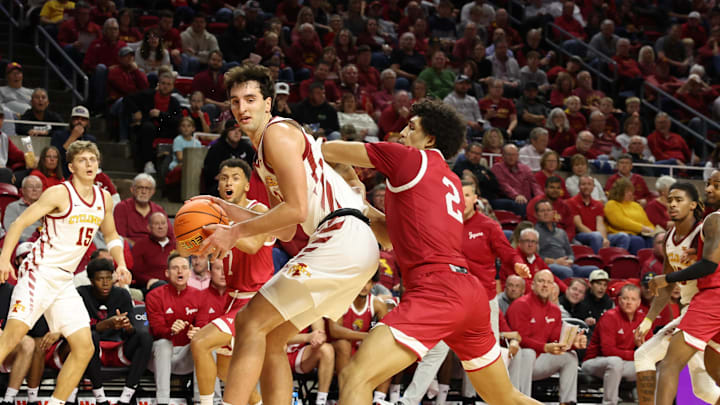Nov 18, 2024; Ames, Iowa, USA; IUPUI Jaguars forward DeSean Goode (2) defends Iowa State Cyclones forward Milan Momcilovic (22) at James H. Hilton Coliseum. Mandatory Credit: Reese Strickland-Imagn Images