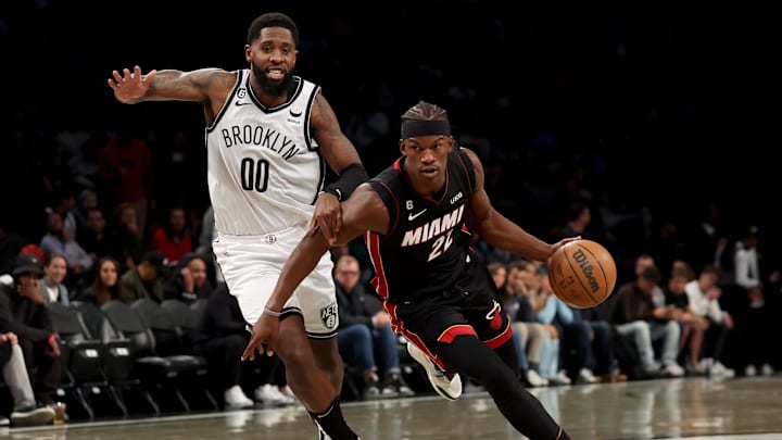 Oct 6, 2022; Brooklyn, New York, USA; Miami Heat forward Jimmy Butler (22) drives to the basket against Brooklyn Nets forward Royce O'Neale (00) during the first quarter at Barclays Center. Mandatory Credit: Brad Penner-Imagn Images