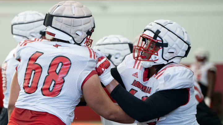Louisville football offensive linemen Rasheed Miller (60) and Michael Gonzalez (68) run drills during spring practice on Saturday, March 23, 2024 at the Trager practice facility in Louisville, Ky.