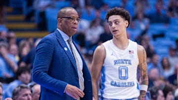 Nov 18, 2025; Chapel Hill, North Carolina, USA; North Carolina Tar Heels head coach Hubert Davis talks to guard Kyan Evans (0) during the second half against the Navy Midshipmen at Dean E. Smith Center. Mandatory Credit: Scott Kinser-Imagn Images