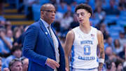 Nov 18, 2025; Chapel Hill, North Carolina, USA; North Carolina Tar Heels head coach Hubert Davis talks to guard Kyan Evans (0) during the second half against the Navy Midshipmen at Dean E. Smith Center. Mandatory Credit: Scott Kinser-Imagn Images