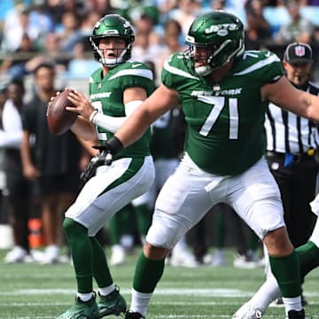 Aug 12, 2023; Charlotte, North Carolina, USA;  New York Jets quarterback Zach Wilson (2) looks to pass as guard Wes Schweitzer (71) blocks in the first quarter at Bank of America Stadium. 