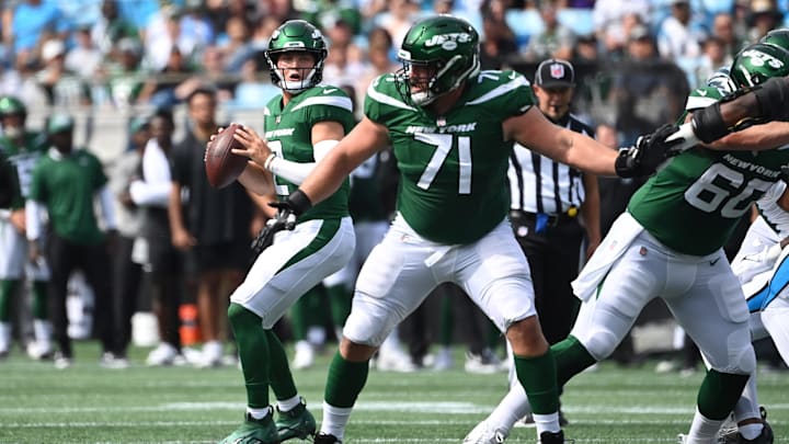 Aug 12, 2023; Charlotte, North Carolina, USA;  New York Jets quarterback Zach Wilson (2) looks to pass as guard Wes Schweitzer (71) blocks in the first quarter at Bank of America Stadium. 