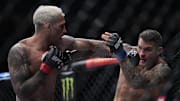 Dec 11, 2021; Las Vegas, Nevada, USA; Charles Oliveira moves in with a hit against Dustin Poirier during UFC 269 at T-Mobile Arena. Mandatory Credit: Stephen R. Sylvanie-Imagn Images