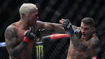 Dec 11, 2021; Las Vegas, Nevada, USA; Charles Oliveira moves in with a hit against Dustin Poirier during UFC 269 at T-Mobile Arena. Mandatory Credit: Stephen R. Sylvanie-Imagn Images