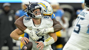 Nov 10, 2024; Inglewood, California, USA;  Tennessee Titans quarterback Will Levis (8) is sacked by Los Angeles Chargers linebacker Bud Dupree (48) in the second half at SoFi Stadium. Mandatory Credit: Jayne Kamin-Oncea-Imagn Images