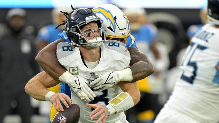 Nov 10, 2024; Inglewood, California, USA;  Tennessee Titans quarterback Will Levis (8) is sacked by Los Angeles Chargers linebacker Bud Dupree (48) in the second half at SoFi Stadium. Mandatory Credit: Jayne Kamin-Oncea-Imagn Images