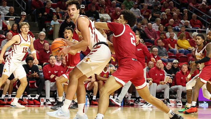 Nov 18, 2024; Ames, Iowa, USA; IUPUI Jaguars forward DeSean Goode (2) defends Iowa State Cyclones forward Milan Momcilovic (22) at James H. Hilton Coliseum. Mandatory Credit: Reese Strickland-Imagn Images