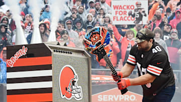 Former Cleveland Browns player Peyton Hillis breaks a guitar with Chicago Bears logos on it before the game at Cleveland Browns Stadium. 