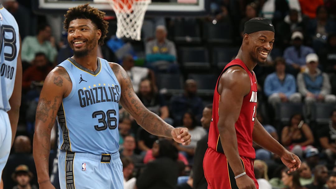 Nov 8, 2023; Memphis, Tennessee, USA; Memphis Grizzlies guard Marcus Smart (36) and Miami Heat forward Jimmy Butler (22) share a laugh during the first half at FedExForum. Mandatory Credit: Petre Thomas-Imagn Images