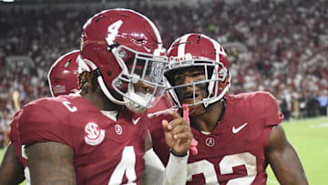 Aug 31, 2024; Tuscaloosa, Alabama, USA;  Alabama Crimson Tide quarterback Jalen Milroe (4) and running back Justice Haynes (22) come to the sideline after Haynes scored on an 85 yard touchdown run against the Western Kentucky Hilltoppers at Bryant-Denny Stadium. Mandatory Credit: Gary Cosby Jr.-Imagn Images