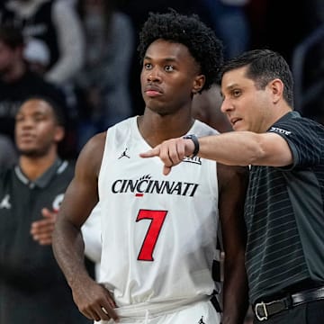 Cincinnati Bearcats head coach Wes Miller walks with guard Keyshuan Tillery (7) on the sideline in the first half of the NCAA Men’s Basketball game between the Cincinnati Bearcats and the Dayton Flyers at Fifth Third Arena in Cincinnati on Tuesday, Nov. 11, 2025.
