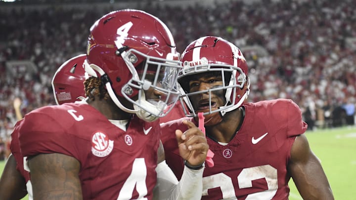 Aug 31, 2024; Tuscaloosa, Alabama, USA;  Alabama Crimson Tide quarterback Jalen Milroe (4) and running back Justice Haynes (22) come to the sideline after Haynes scored on an 85 yard touchdown run against the Western Kentucky Hilltoppers at Bryant-Denny Stadium. Mandatory Credit: Gary Cosby Jr.-Imagn Images