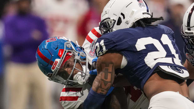 Dec 30, 2023; Atlanta, GA, USA; Mississippi Rebels running back Quinshon Judkins (4) is tackled by Penn State Nittany Lions safety Kevin Winston Jr. (21) during the second half at Mercedes-Benz Stadium. Mandatory Credit: Dale Zanine-USA TODAY Sports