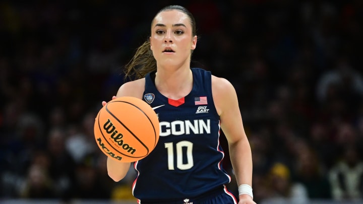 Apr 5, 2024; Cleveland, OH, USA; Connecticut Huskies guard Nika Muhl (10) dribbles the ball against the Iowa Hawkeyes in the semifinals of the Final Four of the womens 2024 NCAA Tournament at Rocket Mortgage FieldHouse. 