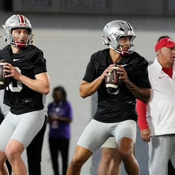 From left, Ohio State Buckeyes quarterbacks Lincoln Kienholz (3), Julian Sayin (10) and Tavien St. Clair (9) drop back to pass during spring football practice at the Woody Hayes Athletic Center in Columbus on March 19, 2025.