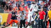 Dec 31, 2024; Orlando, FL, USA; South Carolina Gamecocks wide receiver Nyck Harbor (8) makes the catch over Illinois Fighting Illini defensive back Xavier Scott (14) in the third quarter at Camping World Stadium. Mandatory Credit: Jeremy Reper-Imagn Images