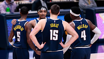 Dec 23, 2020; Denver, Colorado, USA; Denver Nuggets guard Gary Harris (14) with forward Will Barton (5) and center Nikola Jokic (15) and forward Paul Millsap (4) and guard PJ Dozier (35) during a timeout in the fourth quarter against the Sacramento Kings at Ball Arena. Mandatory Credit: Isaiah J. Downing-Imagn Images