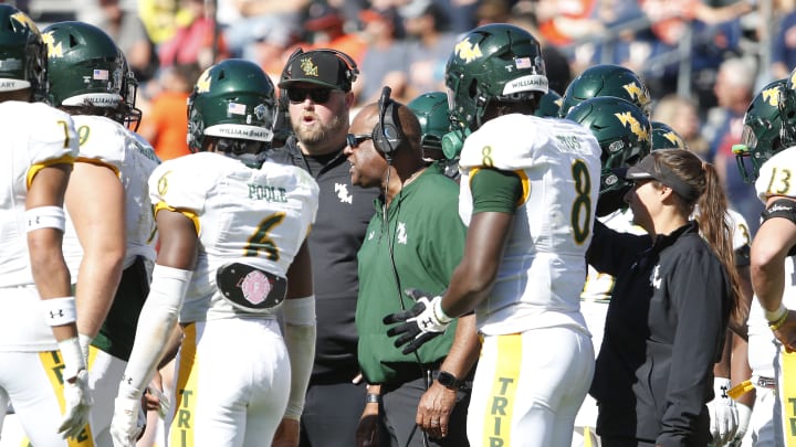 Oct 7, 2023; Charlottesville, Virginia, USA; William & Mary Tribe head coach Mike London (center) huddles with players during a stoppage in play against the Virginia Cavaliers in the second half at Scott Stadium. Mandatory Credit: Amber Searls-USA TODAY Sports